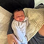 Anaya joined the competition — help win amazing prizes! newborn, baby, infant, sleeping, striped_clothing, onesie, blanket, couch, pillow, adult_hand, indoor, resting, peaceful, cozy, soft_lighting, home, person, human, child, family