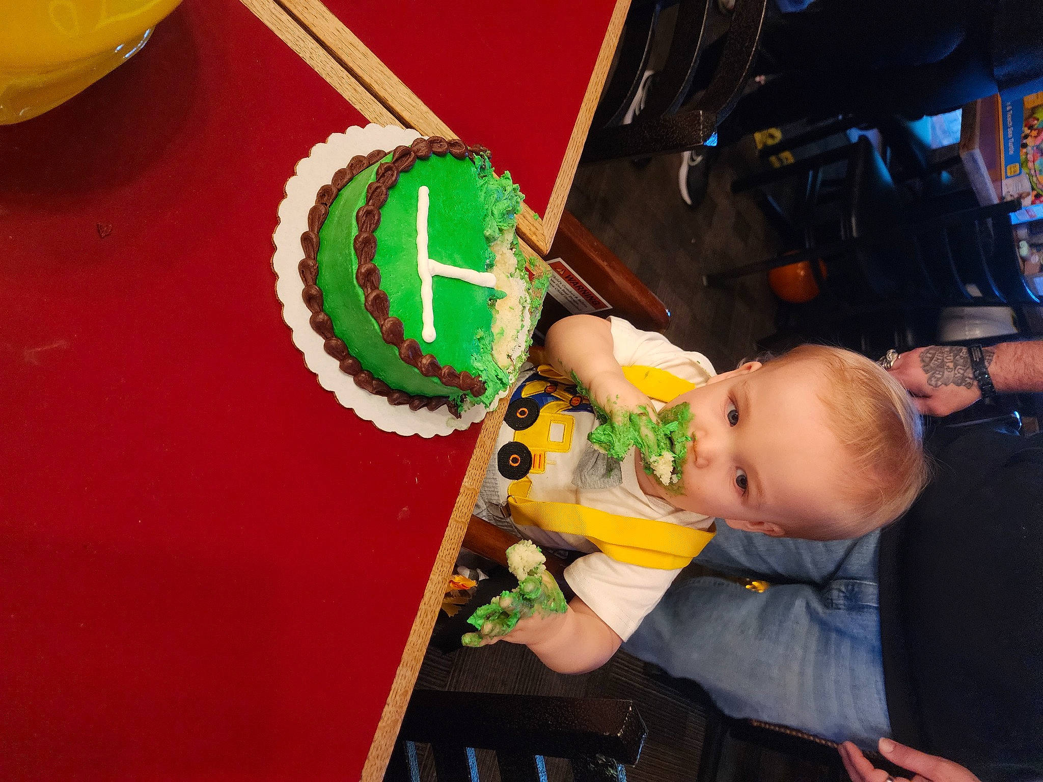 Steven is registered to the contest to win money with this photo: baby, baby_products, child, drum, event, finger, flag, fun, idiophone, indoor_games_and_sports, lap, nail, recreation, room, sitting, tableware, toddler, toy, watch, yellow