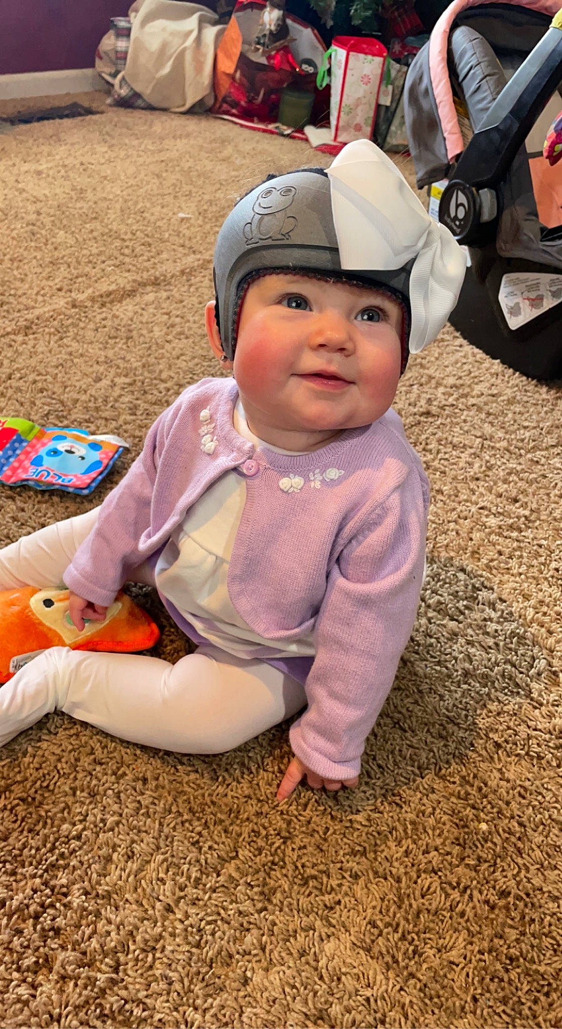 Amelia is registered to the contest to win money with this photo: baby, baby_toddler_clothing, baseball_cap, cap, child, flooring, fun, grass, happy, headwear, leisure, person, personal_protective_equipment, play, recreation, sitting, smile, soil, toddler, tree