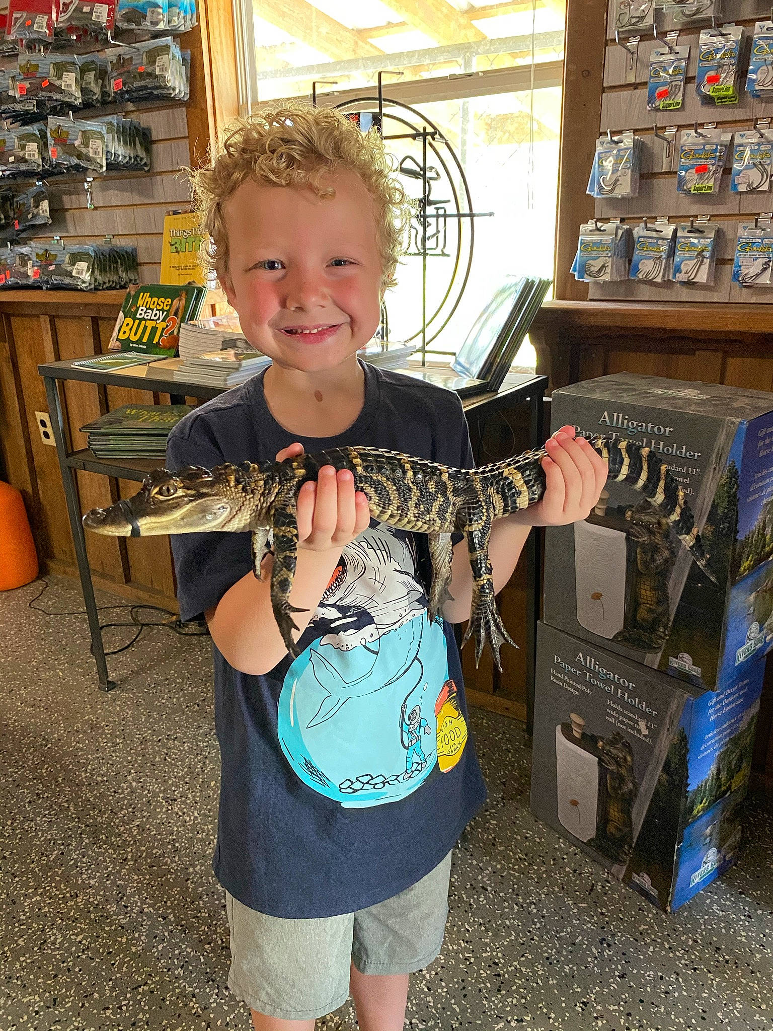 Bradley joined the competition — help win amazing prizes! audio_equipment, box, chair, child, electric_blue, eyewear, fashion_accessory, fun, happy, joy, pattern, person, play, retail, shelf, shelving, shorts, sleeve, smile, standing