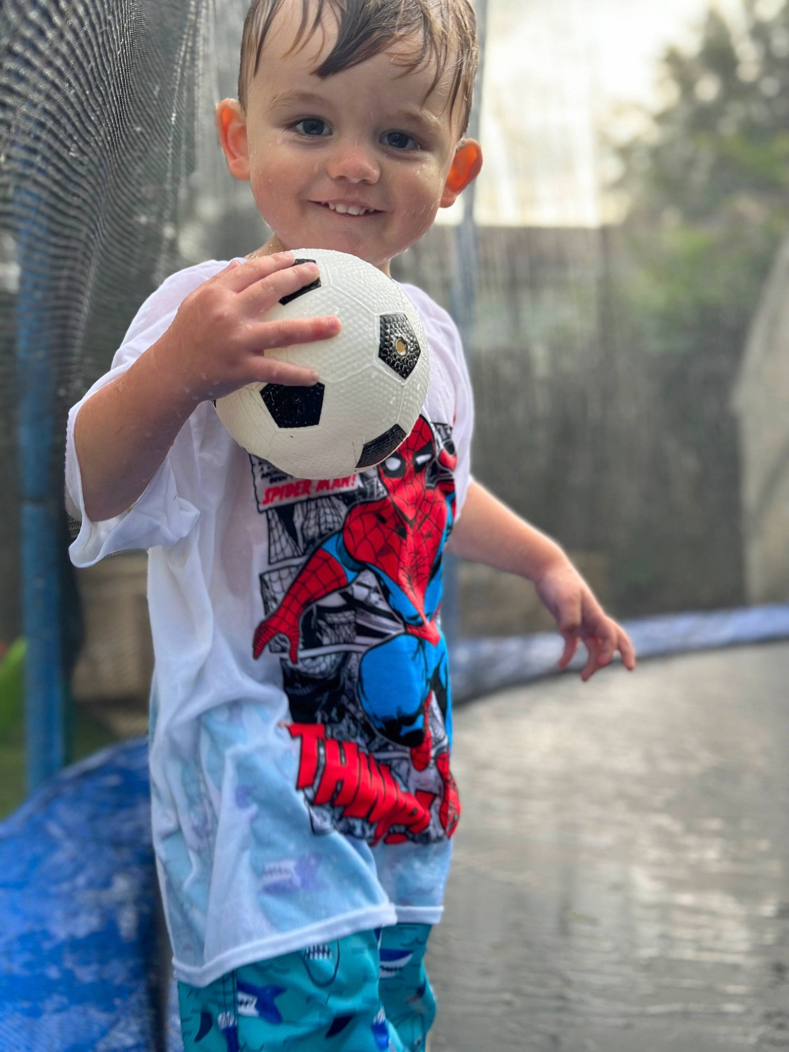 Timothy is registered to the contest to win money with this photo: baby_toddler_clothing, ball, child, cool, electric_blue, football, fun, grass, happy, joy, leisure, pattern, person, plant, recreation, sleeve, soccer_ball, t_shirt, toddler, toy