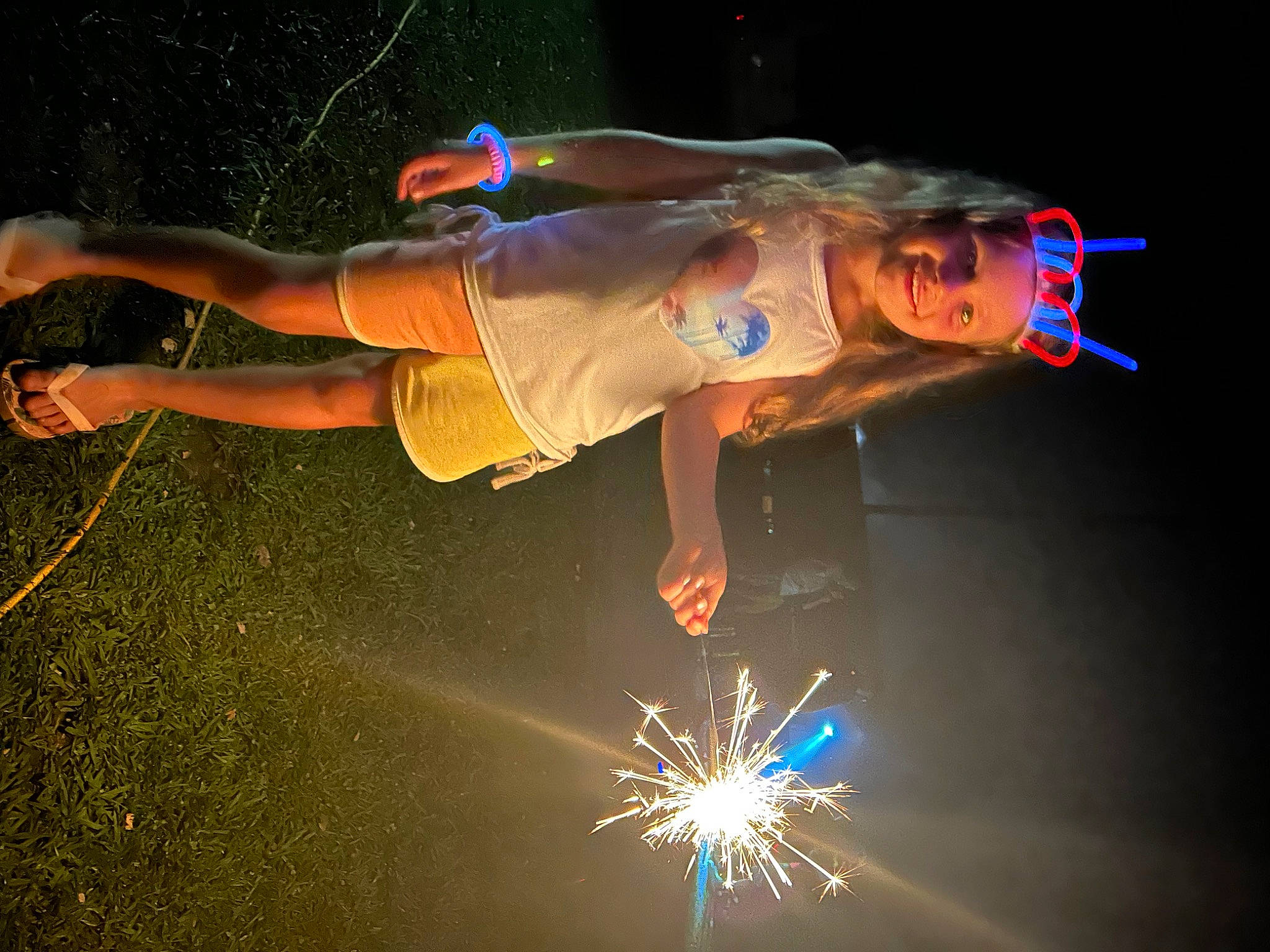 Kylie is registered to the contest to win money with this photo: balance, dancer, darkness, elbow, electric_blue, entertainment, event, fireworks, flash_photography, fun, headwear, heat, joy, lens_flare, light, new_year, night, performance_art, performing_arts, person