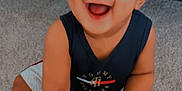 Toriyan joined the competition — help win amazing prizes! baby, toddler, smile, happy, carpet, hand, child, sitting, indoor, person, clothing, shorts, tank_top, skin, face, eyes, mouth, fingers, adult_hand, wooden_furniture