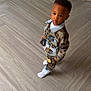 Tyron joined the competition — help win amazing prizes! toddler, child, indoor, floor, denim_jacket, camouflage, pants, socks, wall, door, person, young_child, fashion, standing, expression, hair, flooring, casual_clothing, home, portrait