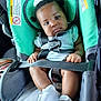 baby, child, car_seat, seatbelt, white_shoes, clothing, infant, car_interior, safety, cute, person, young_child, seat, straps, small_hands, hair_bow, footwear, car, transportation, toddler