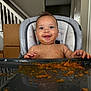 Reighlynn joined the competition — help win amazing prizes! baby, high_chair, messy, food, orange_food, smiling, happy, indoor, face, child, feeding, tray, hands, staircase, cardboard_boxes, home, cute, infant, portrait, kitchen