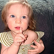Ellia joined the competition — help win amazing prizes! baby, blue_eyes, child, clothing, curly_hair, cute, expression, face, finger_on_lips, green_bow, hand, indoor, person, portrait, quilted_background, sitting, skin, striped_dress, toddler, young_child