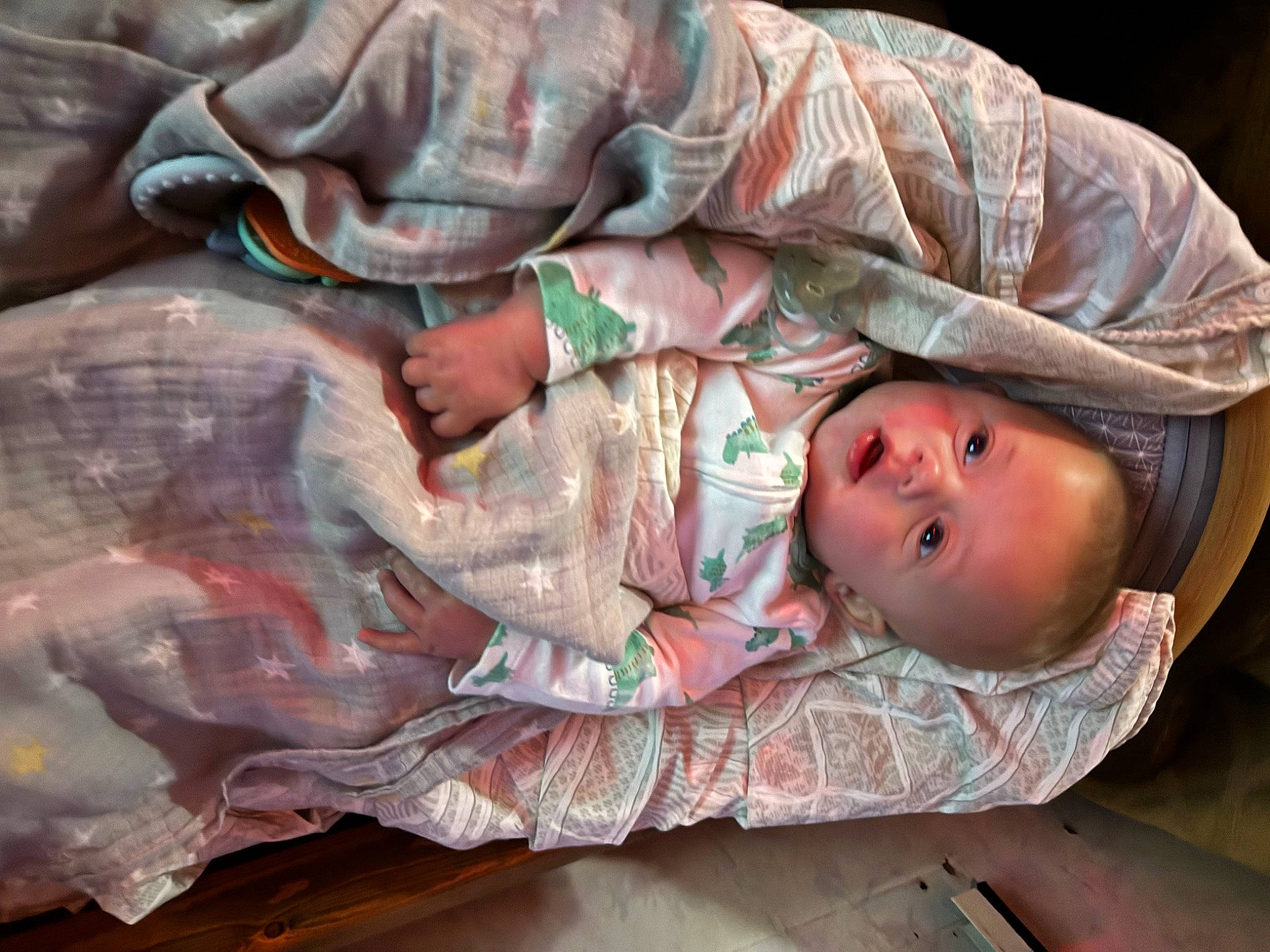 Rex is registered to the contest to win money with this photo: art, baby, baby_products, baby_toddler_clothing, child, comfort, eye, flesh, hand, hat, human_body, linens, mouth, pattern, person, pink, skin, textile, toddler, tree