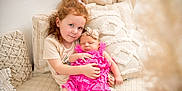 Angela a rejoint le concours — aidez-le/la à gagner de superbes lots ! child, baby, girl, infant, sibling, couch, pillow, pink_dress, headband, indoor, portrait, love, family, cute, sleeping, holding, cozy, homedecor, soft_lighting, smiling