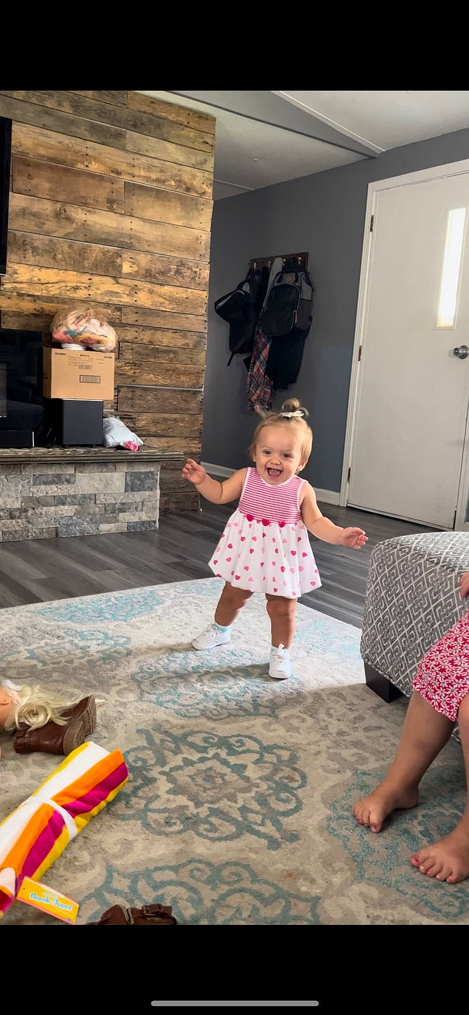 Penelope is registered to the contest to win money with this photo: baby_toddler_clothing, barefoot, door, event, floor, flooring, foot, fun, happy, human, human_leg, joy, leisure, magenta, pattern, person, pink, road_surface, snapshot, standing