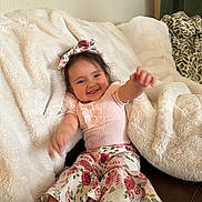 Azalea joined the competition — help win amazing prizes! baby, child, smile, happy, couch, blanket, floral, headband, pants, pink, shoes, indoor, cozy, cute, person, infant, clothing, sitting, home, portrait