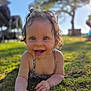 baby, baby_girl, blue_eyes, child, closeup, clothing, curly_hair, daylight, face, grass, hands, happy, infant, nature, outdoor, playful, portrait, smiling, summer, sunlight