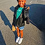 Sky joined the competition — help win amazing prizes! child, girl, smiling, leather_jacket, denim_shorts, white_sneakers, purse, paper_bag, outdoor, street, sunlight, shadow, braided_hair, casual_clothing, happy, standing, fashion, accessories, daytime, sidewalk