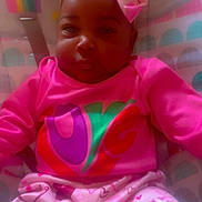 Skylar joined the competition — help win amazing prizes! baby, child, pink_clothing, bow, heart_pattern, playpen, rainbow, sun, infant, cute, portrait, indoor, colorful, soft_glow, sitting, person, young_child, clothing, headwear, expression