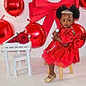 Brihanna Pierre is registered to the contest to win money with this photo: toddler, red_dress, bow, tiara, microphone, balloons, heart_shaped, miniature_piano, roses, stool, gold_shoes, indoor, celebration, child, portrait, cute, festive, toy, music, smile