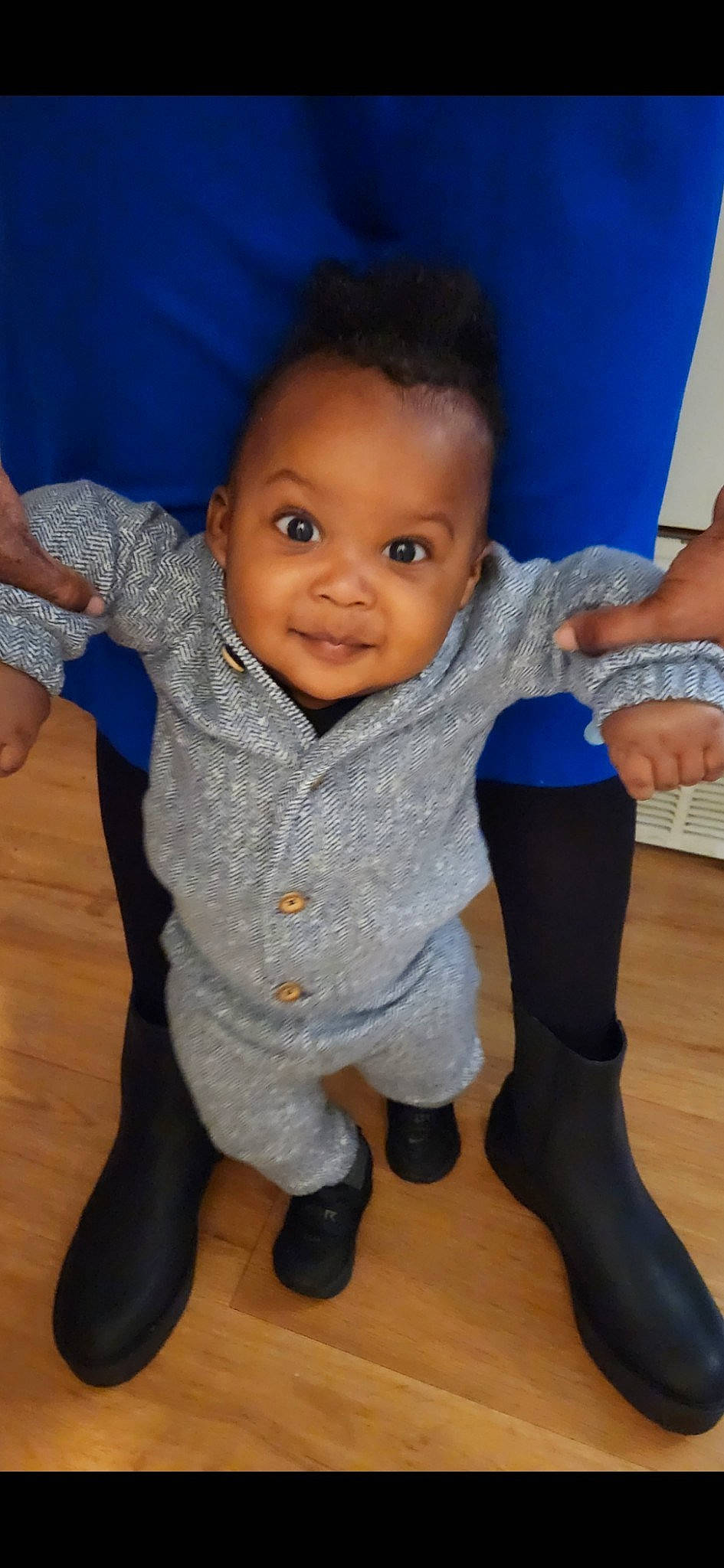 Malik is registered to the contest to win money with this photo: arm, baby_toddler_clothing, cheek, chin, finger, floor, gesture, hairstyle, hand, happy, head, human_body, iris, joint, muscle, nose, person, skin, smile, standing