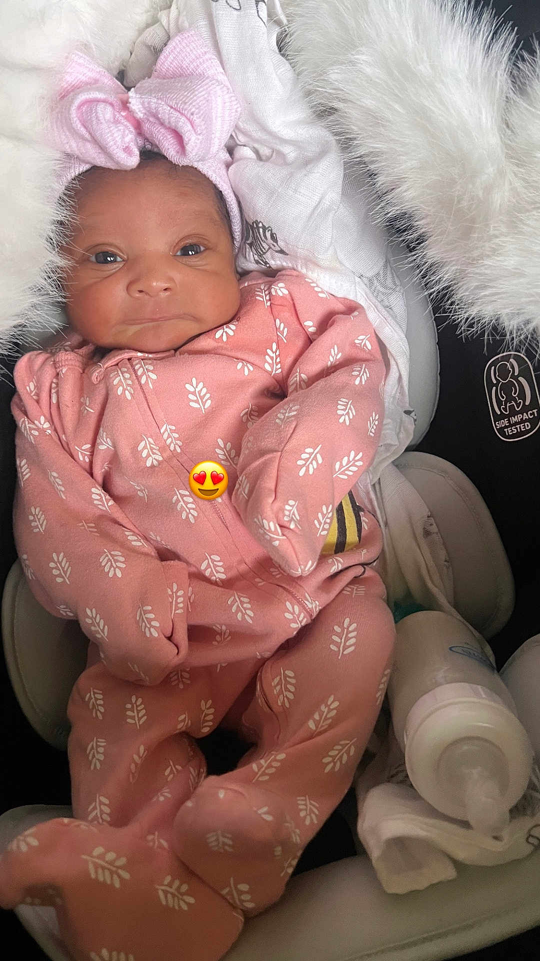 Vanity Marie is registered to the contest to win money with this photo: baby, infant, pink_onesie, headband, blanket, car_seat, baby_bottle, cushion, face, person, newborn, cute, cozy, sleepwear, soft, indoors, resting, adorable, comfort, emoji
