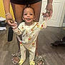 Cayden joined the competition — help win amazing prizes! baby, child, pajamas, winnie_the_pooh, smiling, standing, hands_held, adult, floor, slippers, wood_floor, door, indoor, home, person, footwear, cute, happy, infant, helping_hands