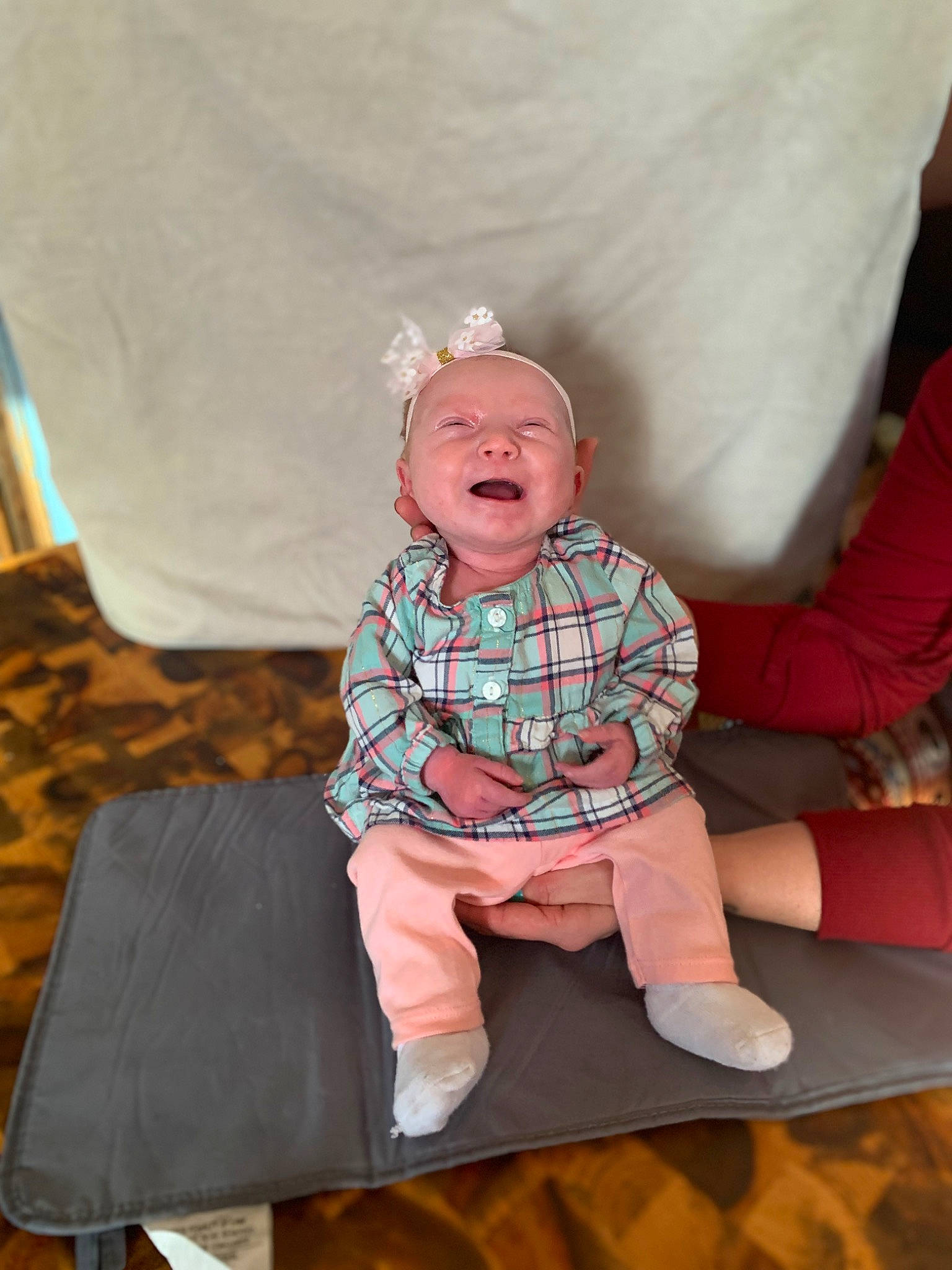 Brynlee joined the competition — help win amazing prizes! baby, baby_toddler_clothing, cheek, child, comfort, eye, flooring, fun, happy, linens, pattern, person, pink, sitting, skin, sleeve, smile, sock, textile, toddler