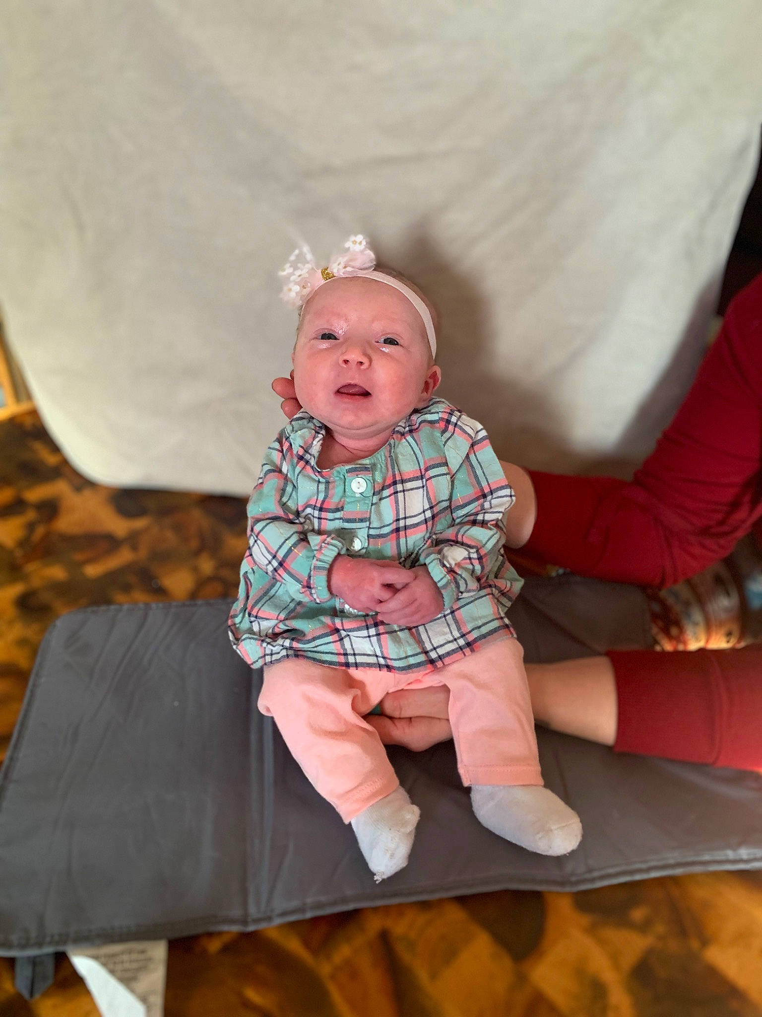 Brynlee joined the competition — help win amazing prizes! baby, baby_toddler_clothing, child, comfort, doll, eye, face, head, linens, pattern, person, plaid, room, sitting, skin, sleeve, sock, tartan, textile, toddler