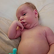 Nash joined the competition — help win amazing prizes! baby, infant, pacifier, skin, hand, face, expression, lying_down, soft_surface, newborn, cute, chubby, portrait, resting, child, human, young, indoors, relaxed, peaceful