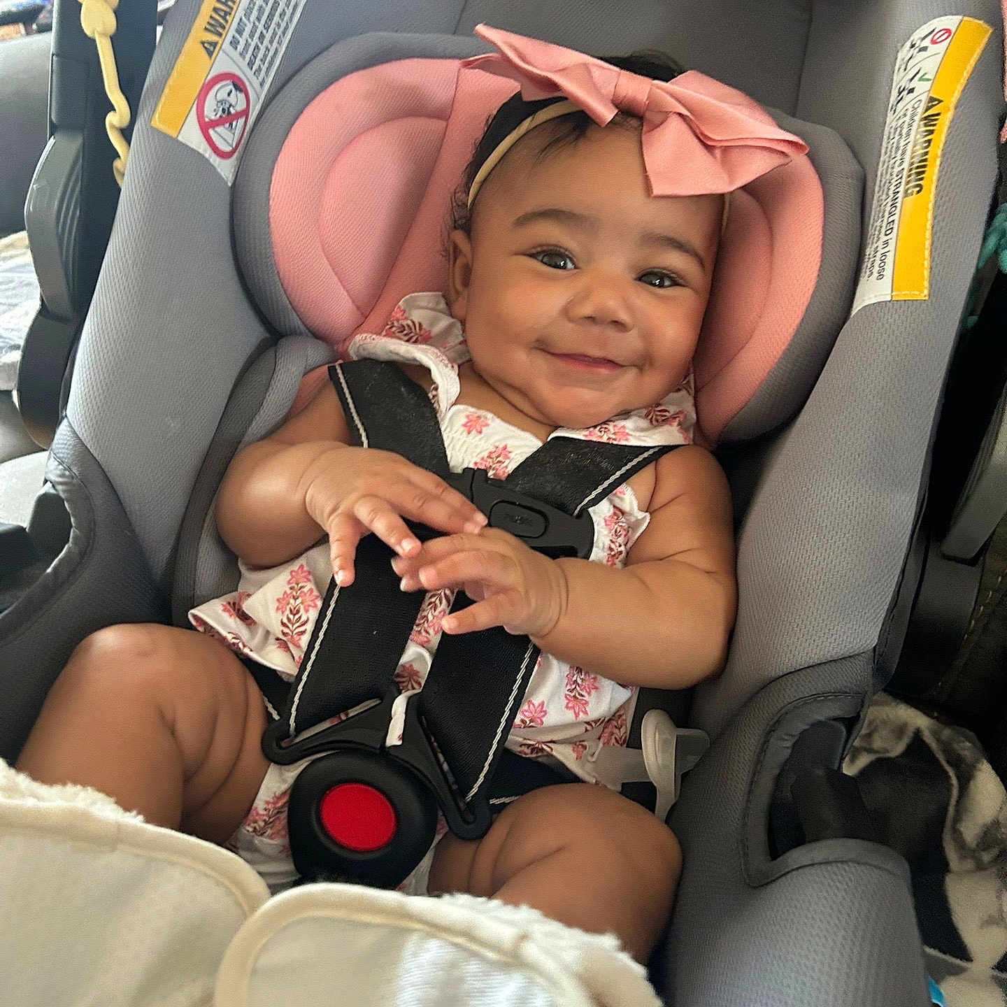 Mylah joined the competition — help win amazing prizes! baby, car_seat, child, clothing, cute, fabric, happy, headband, indoor, infant, person, pink_bow, portrait, safety, seatbelt, sitting, skin, smiling, soft, toddler