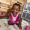 toddler, child, smiling, pink_outfit, mermaid, indoor, wooden_drawers, baby_gate, playmat, crawling, happy, cute, portrait, person, baby, floor, clothing, hand, hair_bow, home