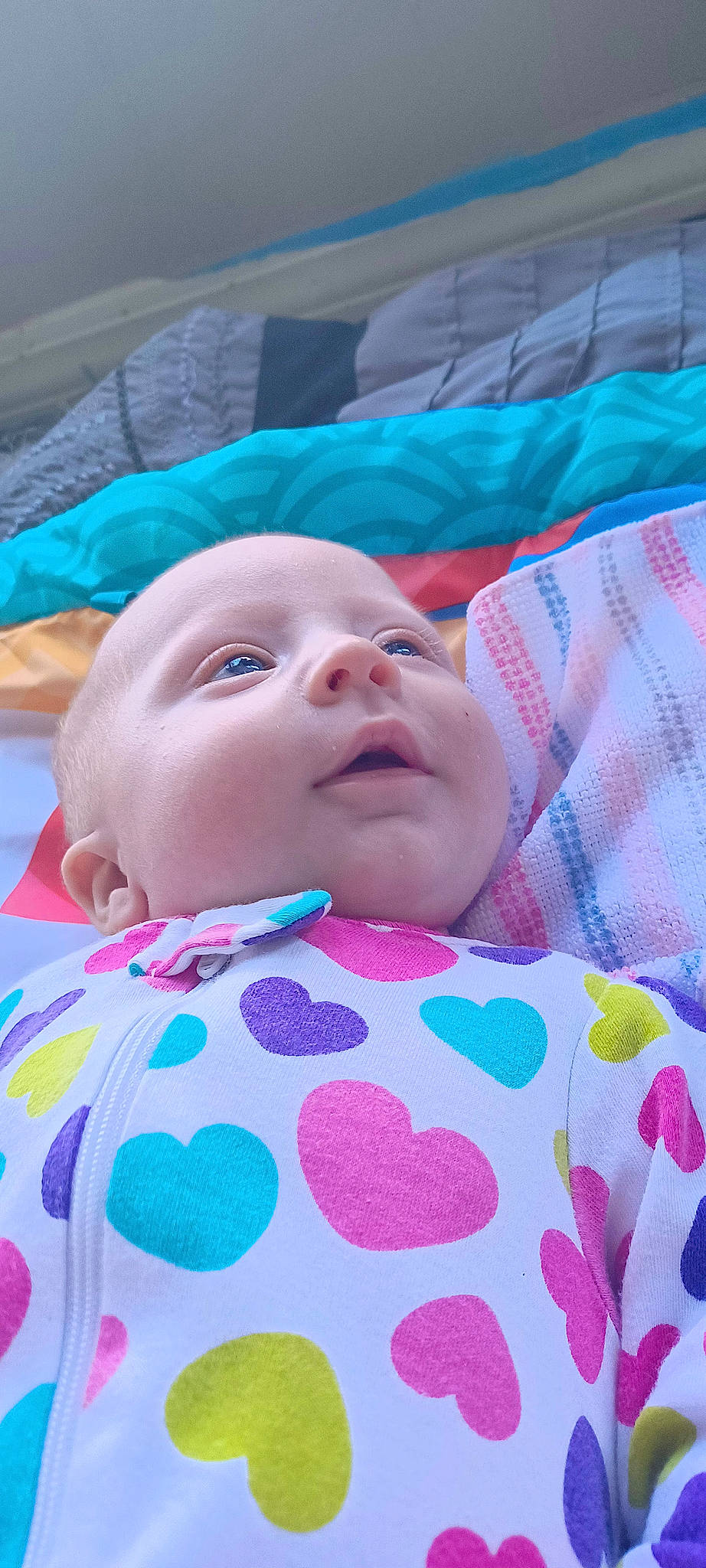 Jianna is registered to the contest to win money with this photo: baby, baby_products, baby_toddler_clothing, bedding, cheek, child, close_up, comfort, event, eye, fun, grass, linens, magenta, pattern, person, pink, skin, sleeve, textile