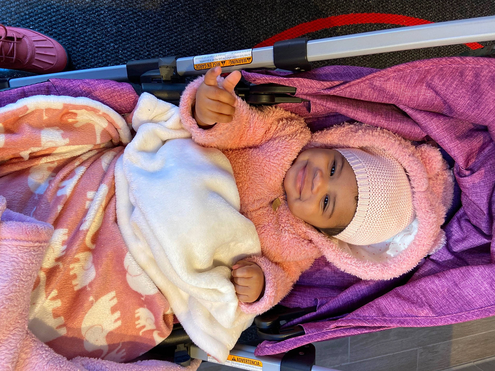 Madisyn is registered to the contest to win money with this photo: art, baby, baby_products, baby_toddler_clothing, child, doll, eyelash, fashion_accessory, hat, headgear, headwear, infant_bed, joy, linens, peach, person, pink, room, skin, textile