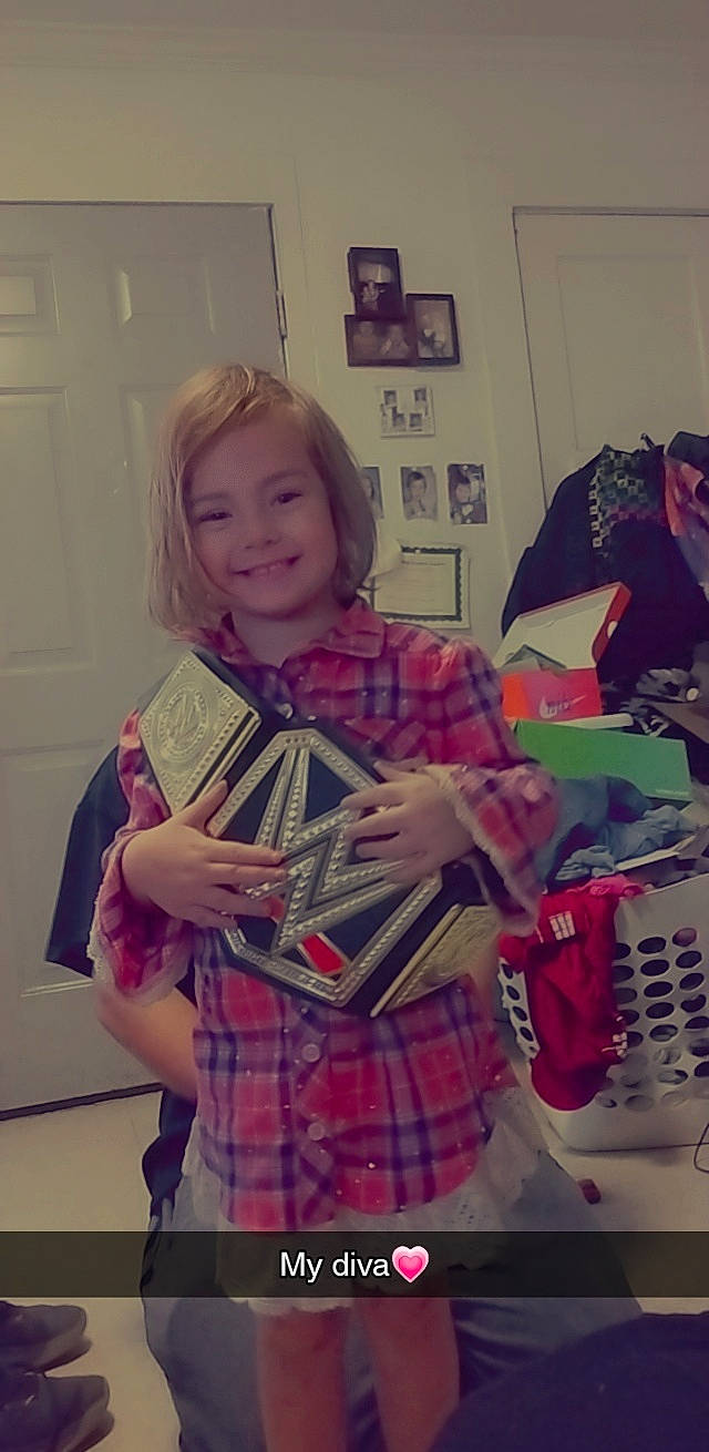 Kinsley joined the competition — help win amazing prizes! bag, blond, carmine, child, event, fashion_accessory, happy, holiday, joy, linens, pattern, person, picture_frame, pink, plaid, room, sitting, sleeve, smile, tartan