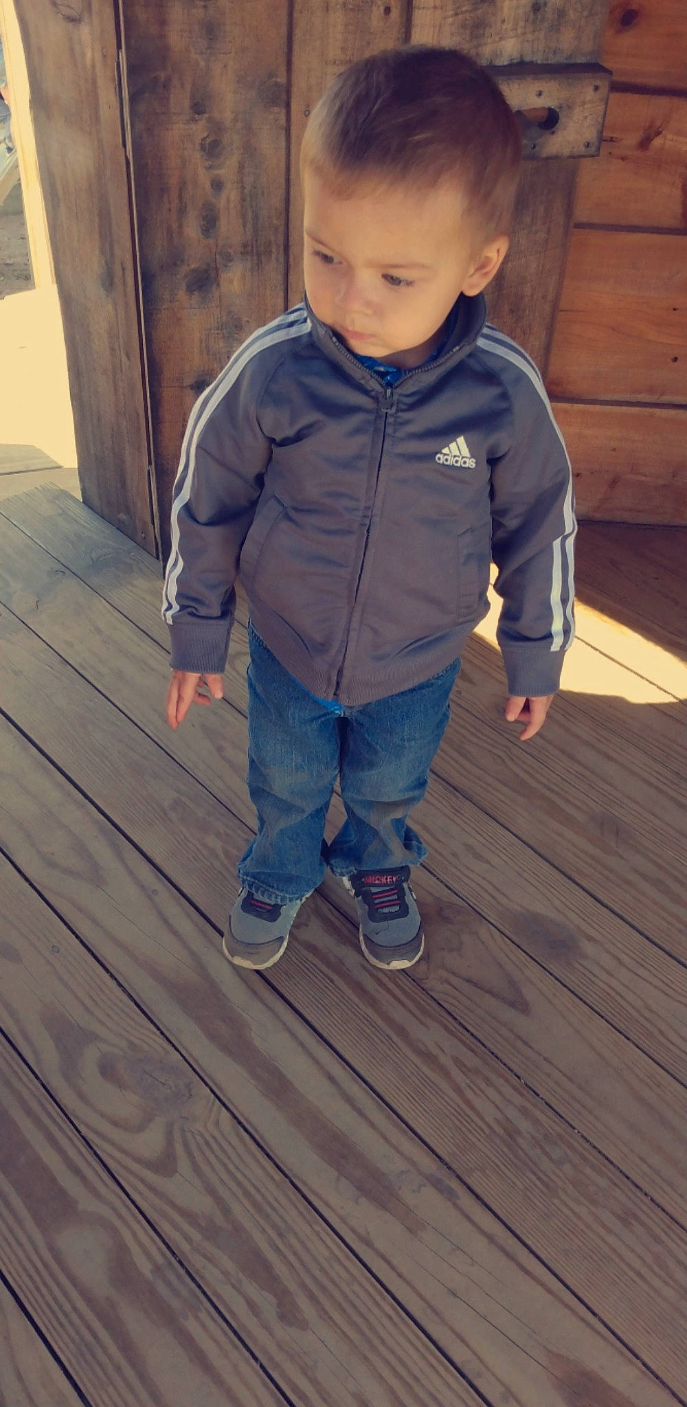 Leon is registered to the contest to win money with this photo: baby, baby_toddler_clothing, cheek, child, deck, denim, electric_blue, floor, flooring, happy, hardwood, person, plank, skin, sleeve, tints_and_shades, toddler, varnish, wood, wood_flooring