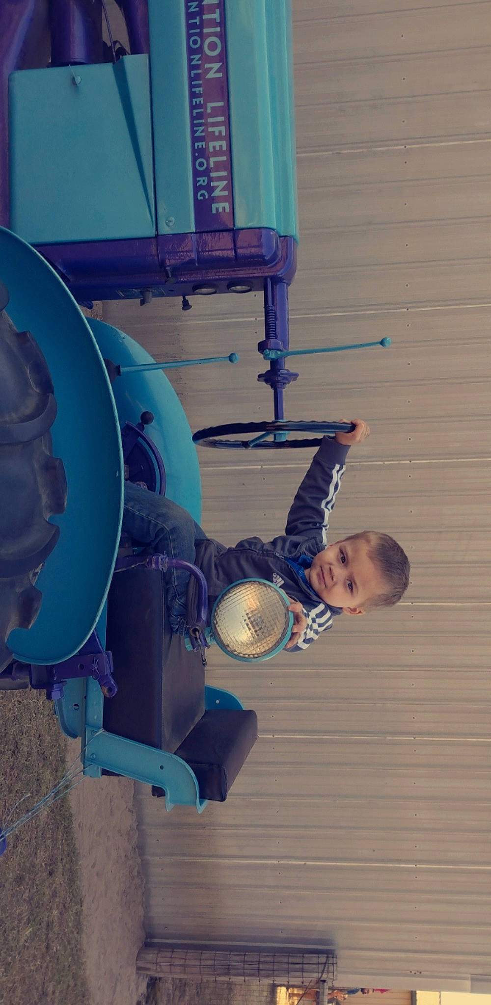 Leon is registered to the contest to win money with this photo: child, circle, cylinder, elbow, electric_blue, engineering, fun, gas, machine, metal, person, personal_protective_equipment, pipe, sitting