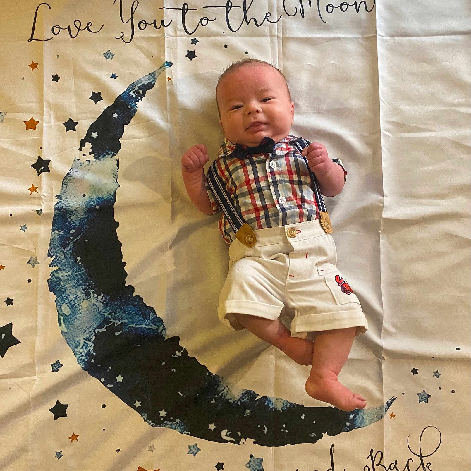 Trystyn is registered to the contest to win money with this photo: baby, bodypart, clothing, cushion, face, finger, furniture, hand, handwriting, head, homedecor, newborn, pants, person, photography, portrait, quilt, shorts, t_shirt, text
