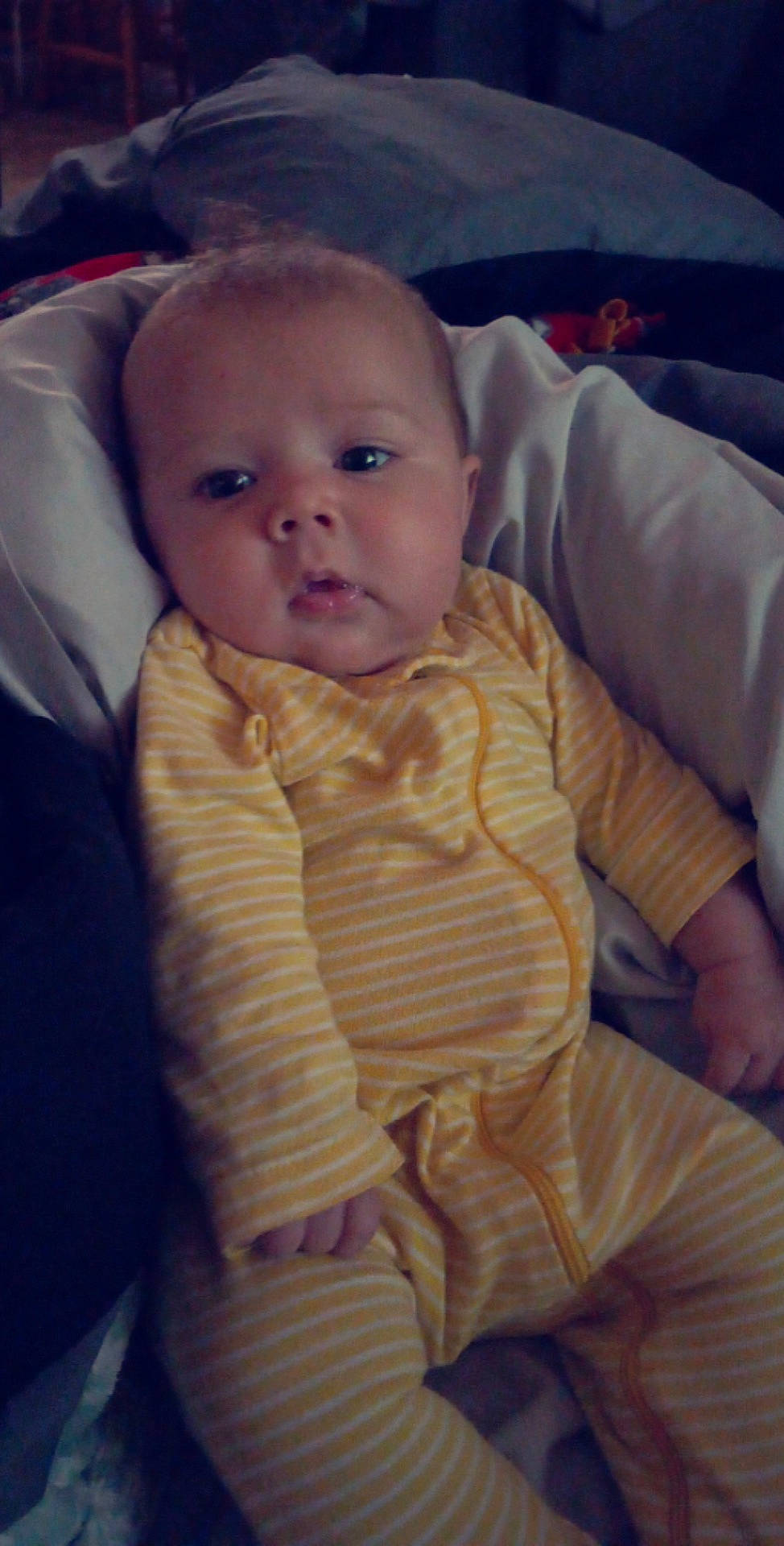 Everest is registered to the contest to win money with this photo: abdomen, baby, baby_toddler_clothing, cheek, child, comfort, finger, fun, hand, iris, linens, lip, neck, nose, person, sitting, skin, sleeve, textile, thumb