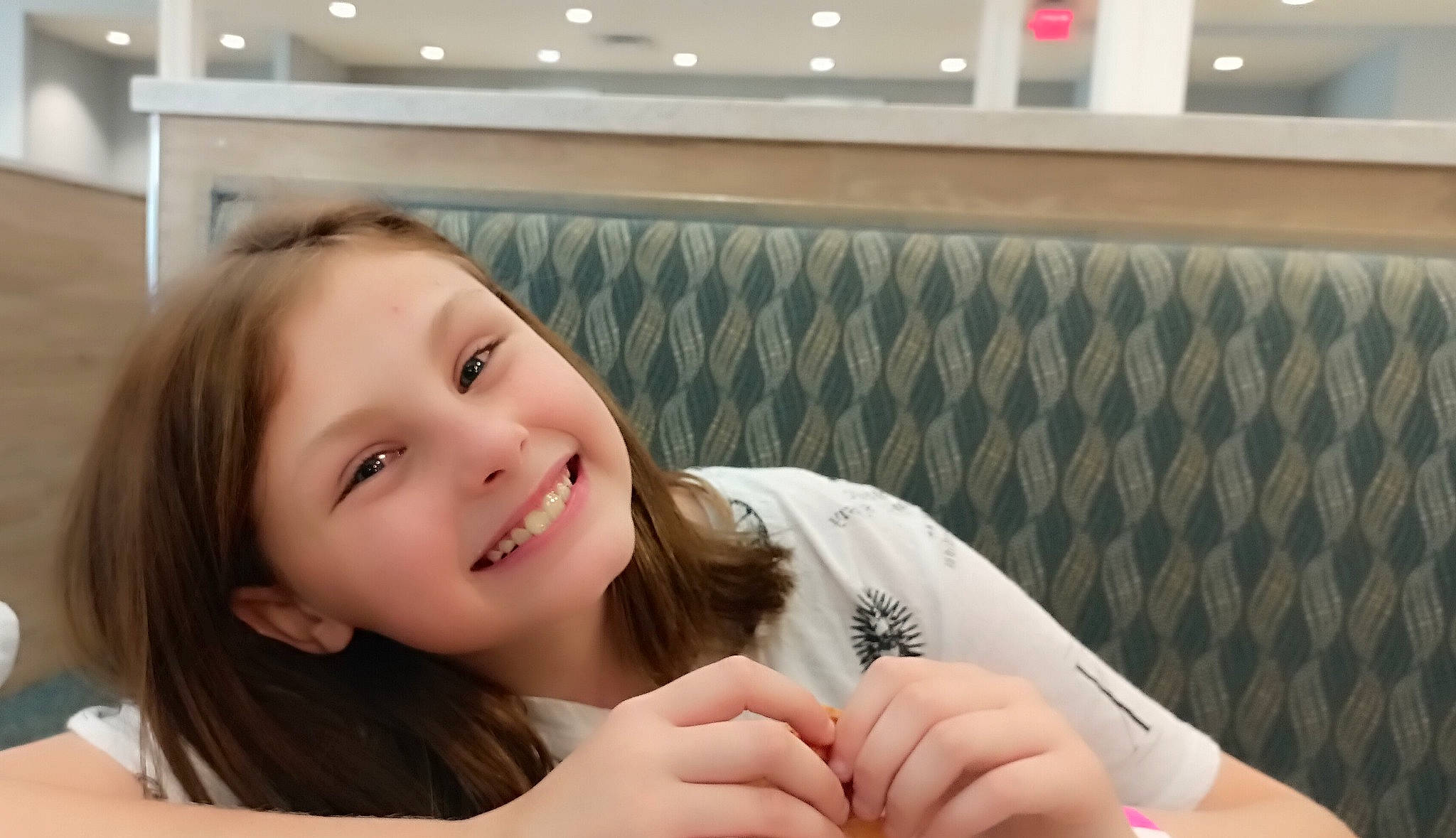 Kylee joined the competition — help win amazing prizes! brown_hair, chair, child, comfort, couch, elbow, eyebrow, finger, fun, gesture, hand, happy, human_leg, joy, long_hair, person, room, skin, smile, thigh