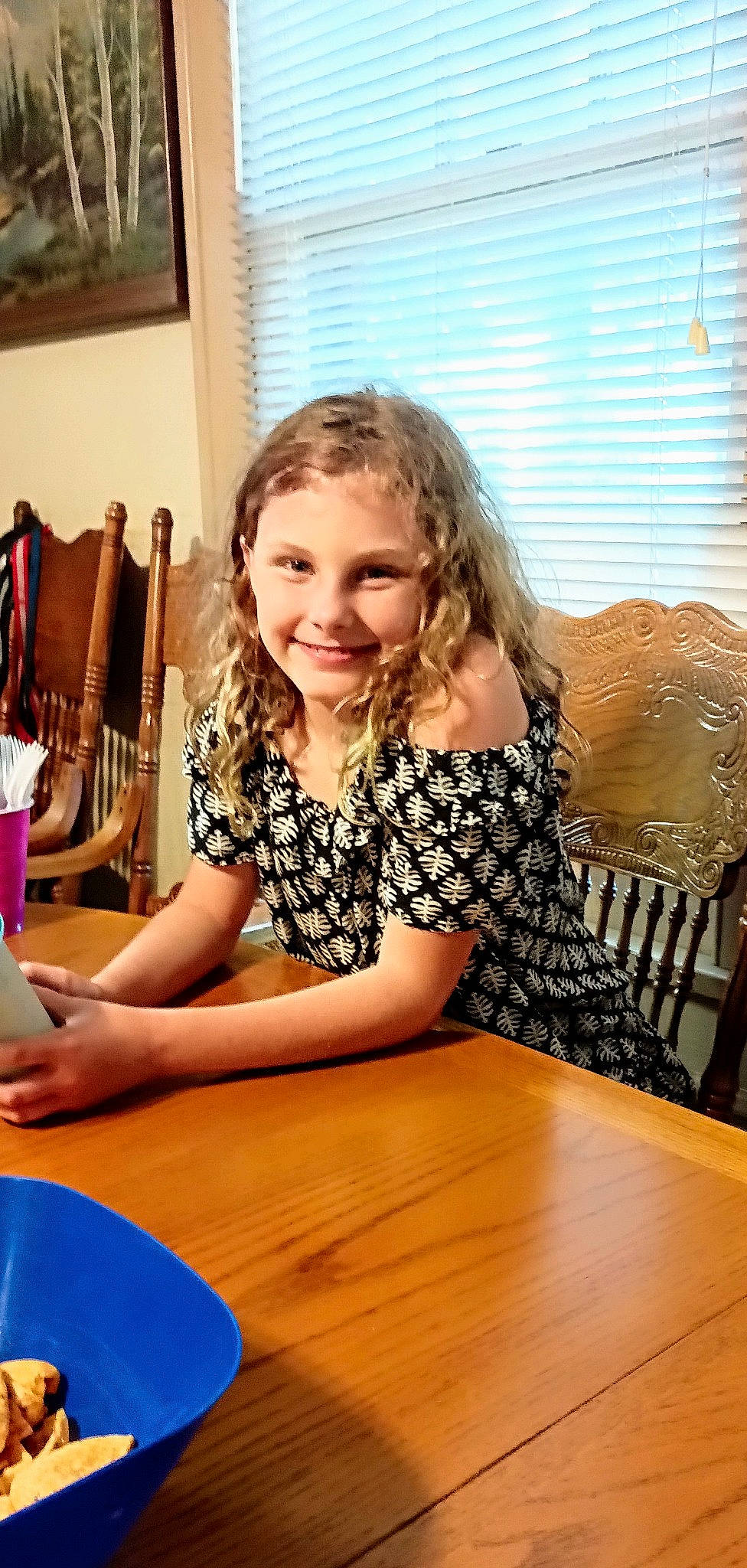 Kylee joined the competition — help win amazing prizes! chair, child, desk, flooring, fun, furniture, happy, hardwood, joy, leisure, person, picture_frame, room, sitting, smile, t_shirt, table, toddler, vacation, varnish