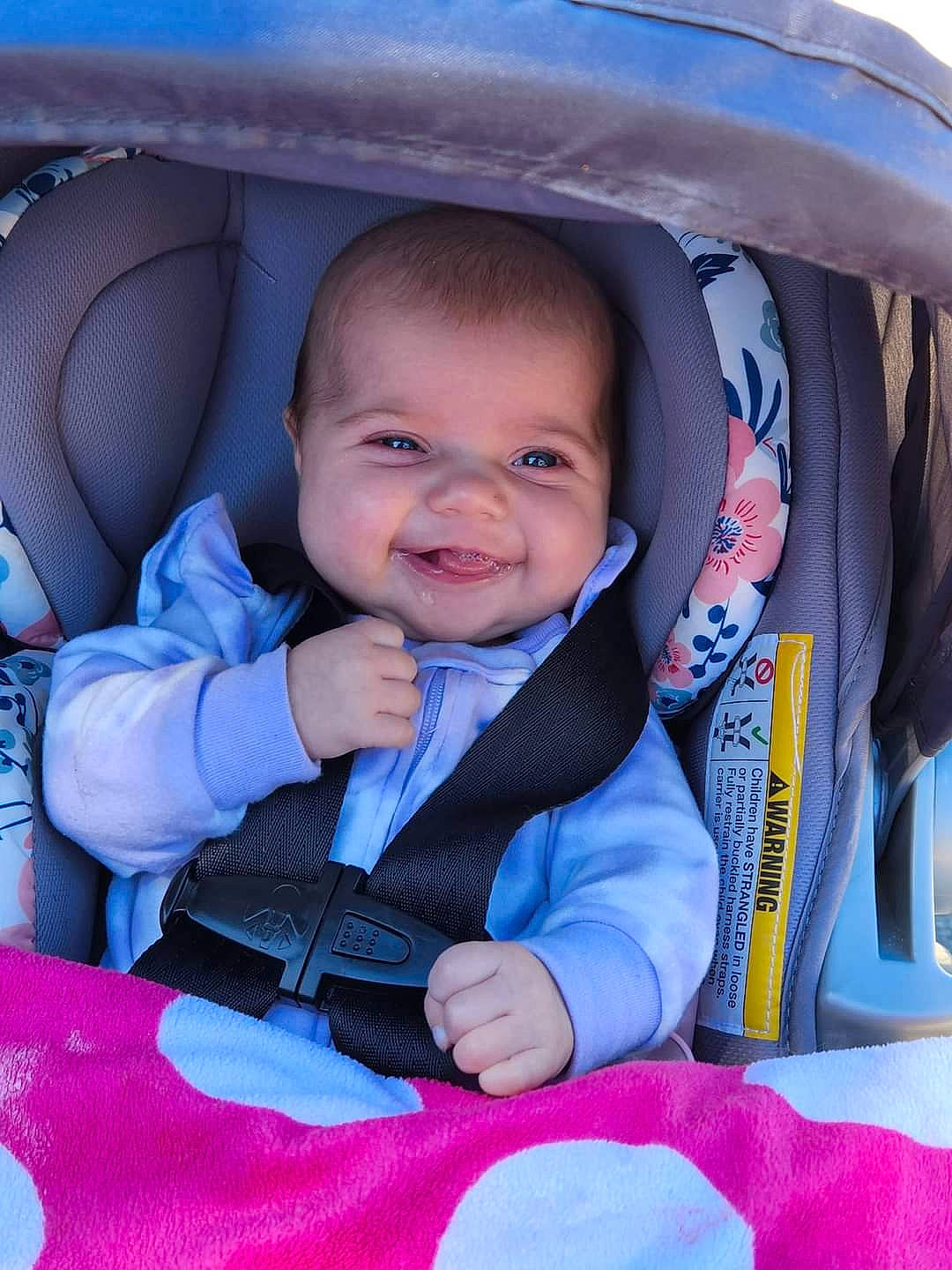 Delilah is registered to the contest to win money with this photo: auto_part, baby, baby_carriage, baby_in_car_seat, baby_products, baby_toddler_clothing, beauty, car_seat, child, comfort, electric_blue, face, facial_expression, fun, happy, luxury_vehicle, person, pink, sitting, smile