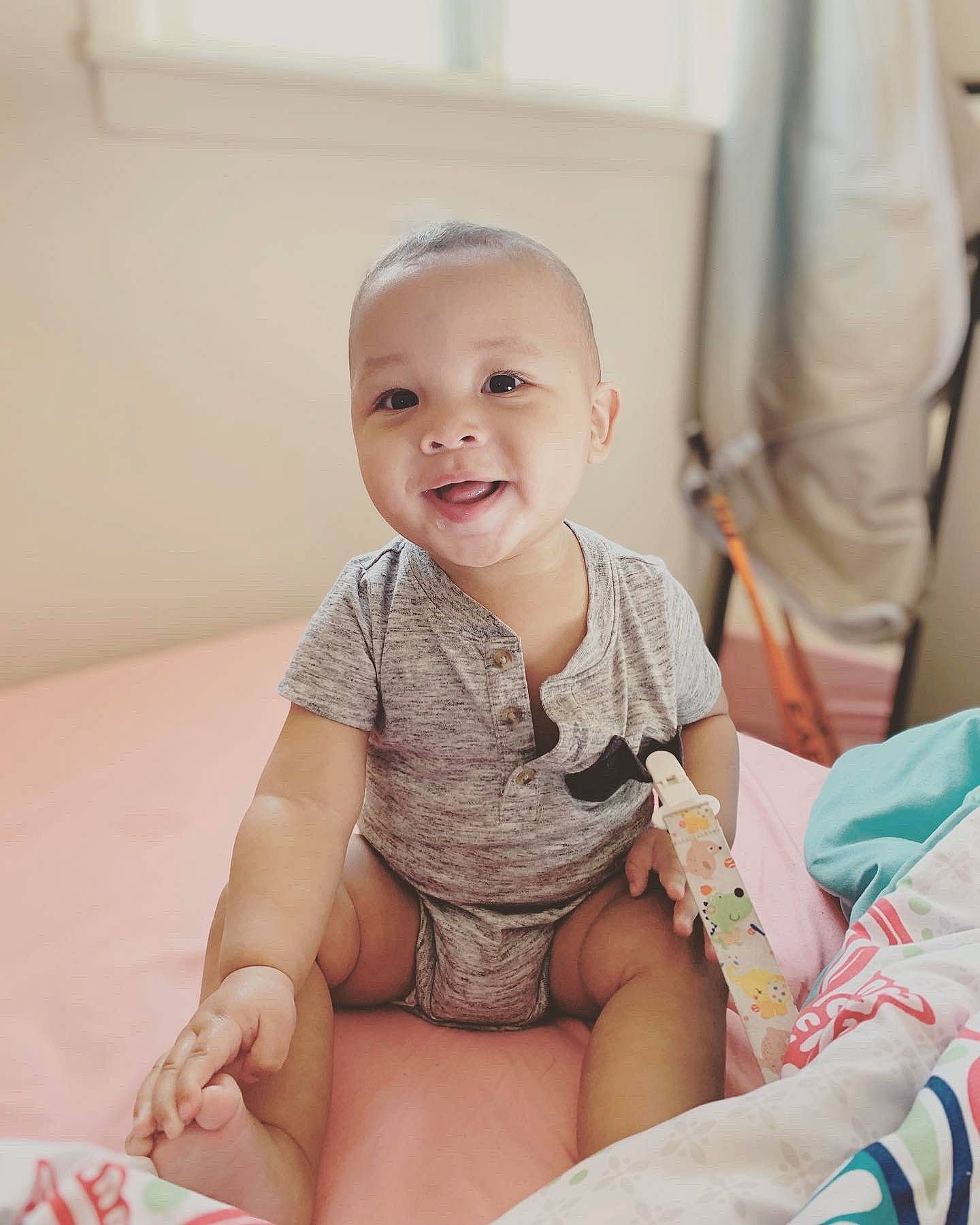 Kobe joined the competition — help win amazing prizes! abdomen, baby, baby_toddler_clothing, cheek, child, comfort, elbow, finger, flooring, happy, human_leg, knee, pattern, person, sitting, skin, sleeve, smile, stomach, thigh
