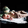 baby, sleeping, plush_toy, frog, blanket, knitted, soft_light, cozy, infant, child, bed, resting, peaceful, cute, portrait, comfort, indoor, warm, toy, nap