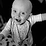 Briec a rejoint le concours — aidez-le/la à gagner de superbes lots ! baby, child, smiling, happy, face, eyes, bib, clothing, black_and_white, indoor, floor, pattern, person, portrait, cute, infant, standing, hand, playful, expression