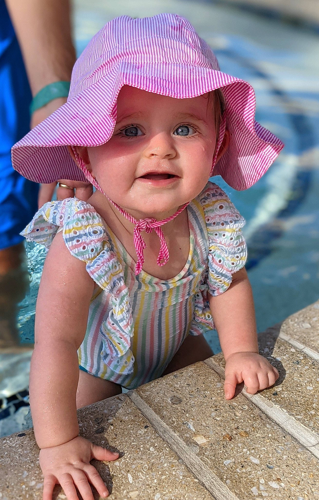 Emelia is registered to the contest to win money with this photo: baby_toddler_clothing, blue, cap, chin, dress, eye, face, facial_expression, fun, happy, hat, head, headwear, human, lip, organ, person, photograph, pink, skin