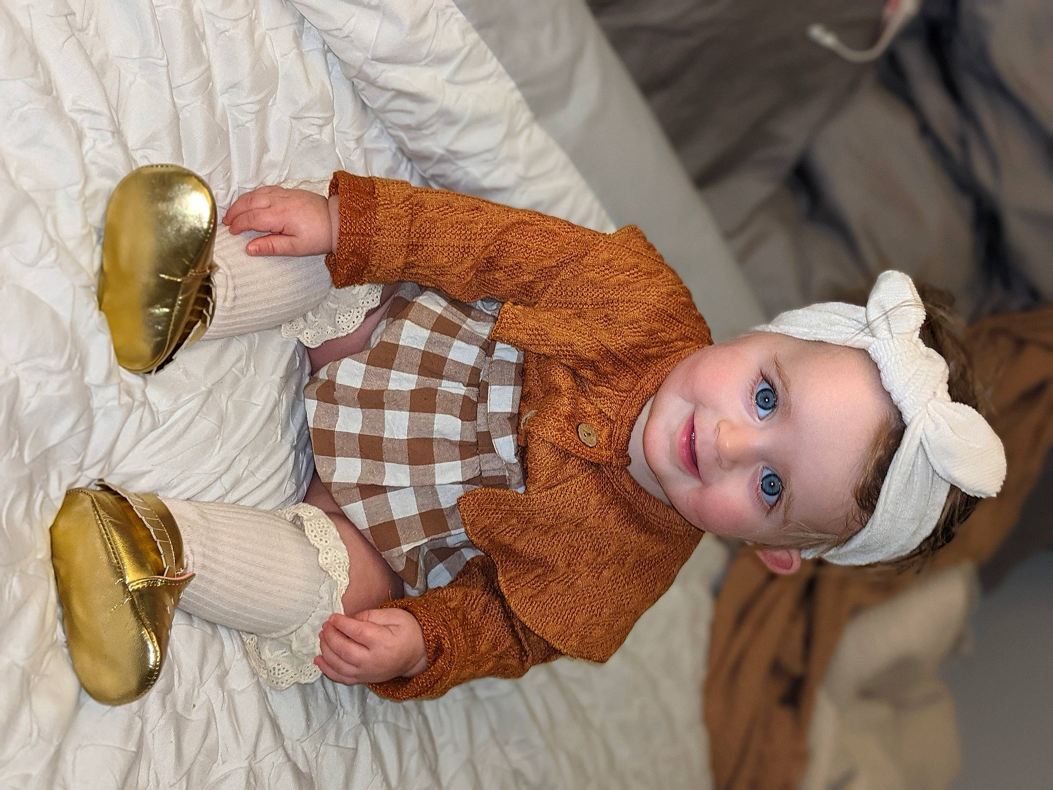 Emelia is registered to the contest to win money with this photo: baby, baby_toddler_clothing, child, finger, food, gesture, hand, happy, joy, pattern, person, plaid, serveware, skin, smile, stemware, tableware, thumb, toddler, wine_glass