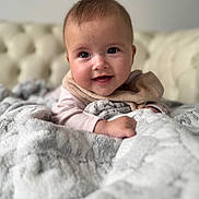 Ariana-Emilija is registered to the contest to win money with this photo: baby, blanket, child, clothing, couch, cozy, cute, face, furniture, happy, head, homedecor, indoor, infant, portrait, skin, smiling, soft, toddler, warm