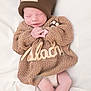 Malachi is registered to the contest to win money with this photo: newborn, baby, sleeping, knitted_sweater, hat, brown, cozy, blanket, soft, peaceful, cute, infant, resting, hands, legs, portrait, indoors, child, warm, toddler