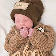 Malachi joined the competition — help win amazing prizes! newborn, baby, sleeping, knitwear, brown_hat, brown_sweater, cozy, soft, cute, infant, portrait, resting, small_hands, warm_clothing, child, indoor, closeup, peaceful, adorable, baby_fashion