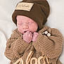 newborn, baby, sleeping, knitwear, brown_hat, brown_sweater, cozy, soft, cute, infant, portrait, resting, small_hands, warm_clothing, child, indoor, closeup, peaceful, adorable, baby_fashion