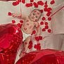 baby, infant, diaper, red_rose_petals, red_balloons, heart_shaped_balloons, lipstick_marks, face, skin, lying_down, white_background, closeup, cute, adorable, love_theme, celebration, indoor, soft_texture, toddler, person