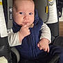 Mike joined the competition — help win amazing prizes! baby, infant, car_seat, child, blue_clothing, sitting, indoors, safety, warning_label, closeup, cute, young_child, seatbelt, portrait, person, head_support, hand, face, expression, footwear