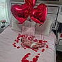 baby, bed, balloon, heart_shaped, rose_petals, lipstick_marks, pillow, blanket, diaper, room, lamp, window, curtain, flower_vase, remote_control, floor, photograph, red, pink, celebration