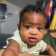 Kemani joined the competition — help win amazing prizes! baby, child, indoor, curious, closeup, person, face, eyes, arm, clothing, hair, skin, expression, infant, portrait, room, background, human, toddler, young